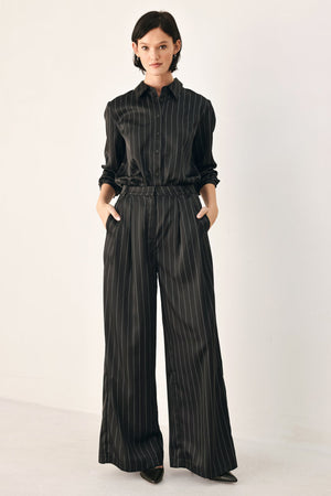Black striped wide-leg pants from Flying Tomato's City After Dark collection, showcasing relaxed fit and stylish pattern.
