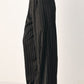 Black Flying Tomato City After Dark striped wide-leg pants with a relaxed fit and bold pattern, displayed on a hanger.