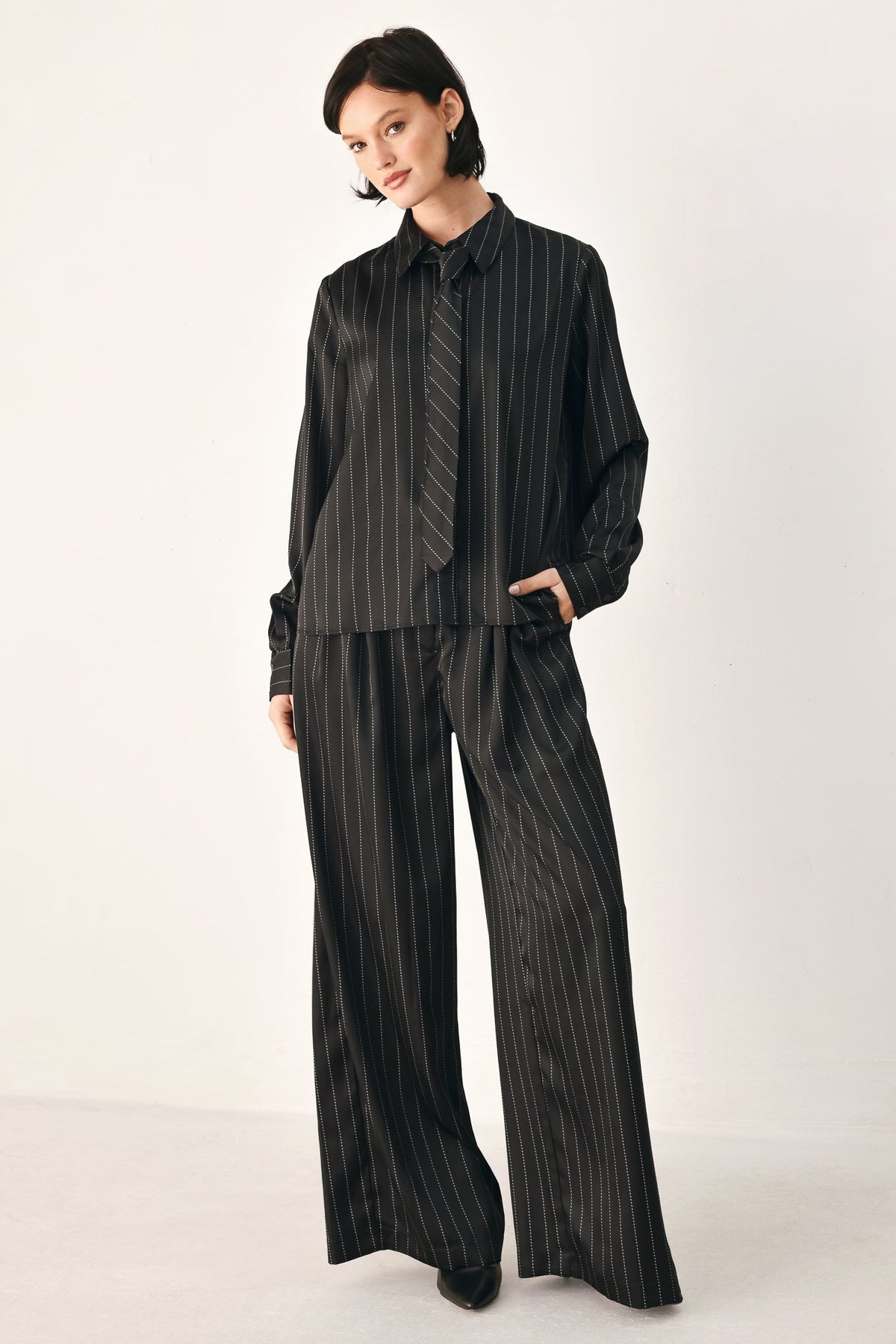 Flying Tomato CITY AFTER DARK striped wide-leg pants in black, featuring a comfortable fit and bold pattern.