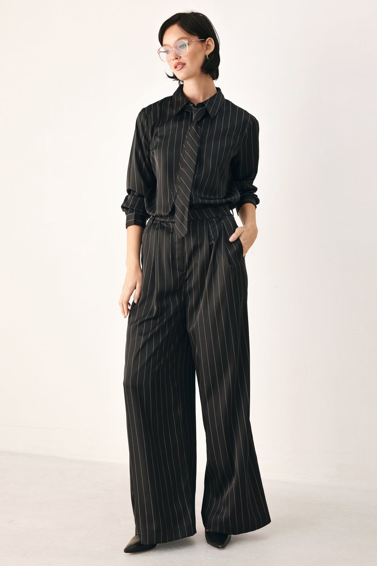 Black striped wide-leg pants by Flying Tomato from the City After Dark collection, featuring a relaxed fit and bold stripe pattern.