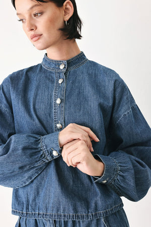 Flying Tomato Indigo Comfort Line denim top with long sleeves and classic collar, shown on a hanger.