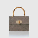 Mini Harriet by thebagicon, a stylish small leather handbag with a structured design and top handle, shown in a full view.