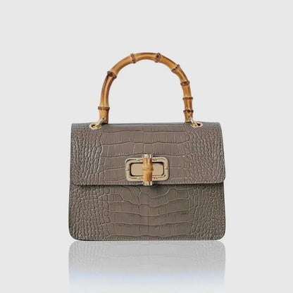 Mini Harriet by thebagicon, a stylish small leather handbag with a structured design and top handle, shown in a full view.