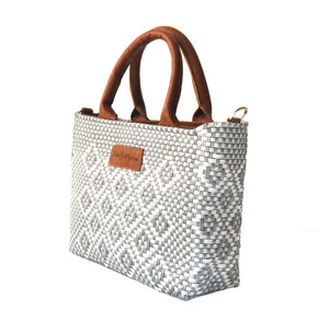 Tan leather Gabrielle small woven crossbody bag by Tin Marin, featuring a compact design with woven detailing.
