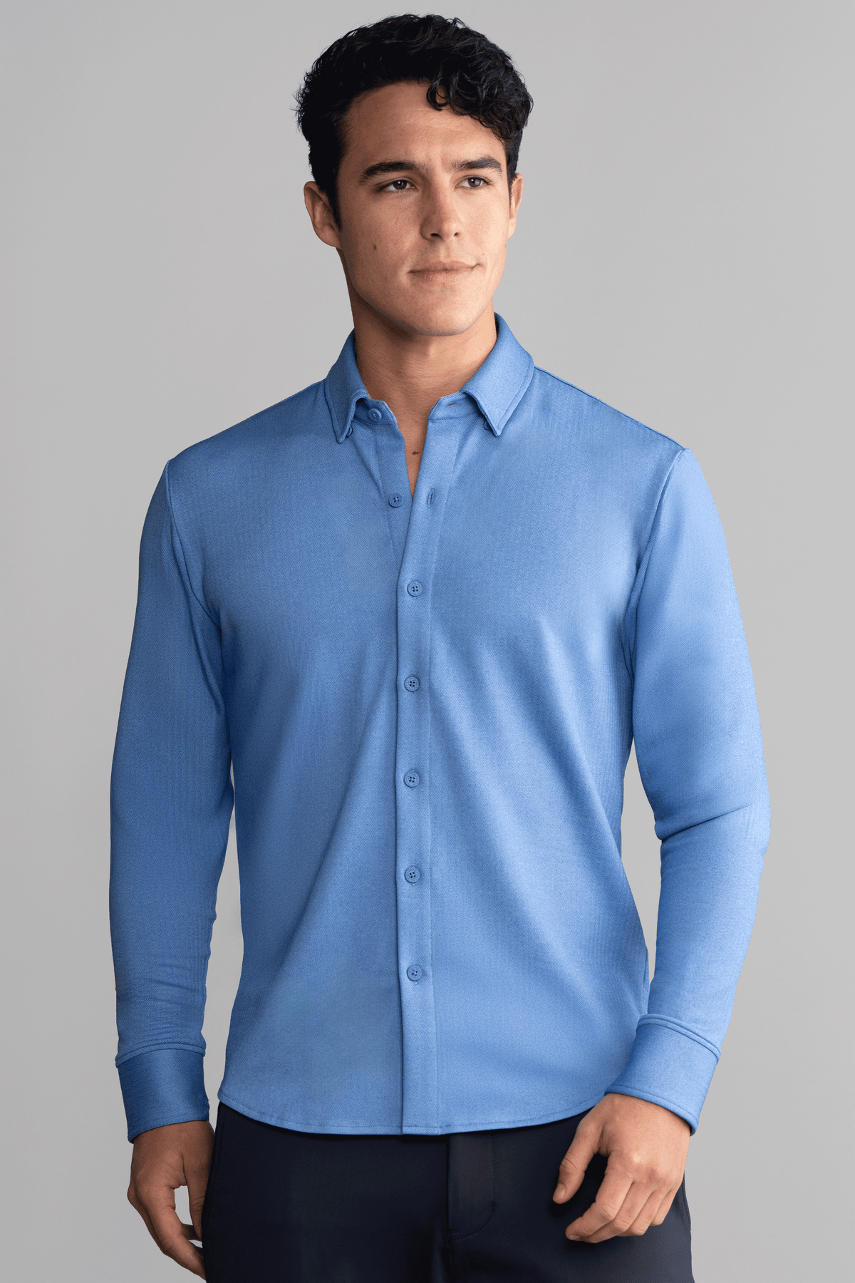 Blue long sleeve button-down polo shirt in herringbone pattern by Twillory, front view showcasing classic collar and button details.