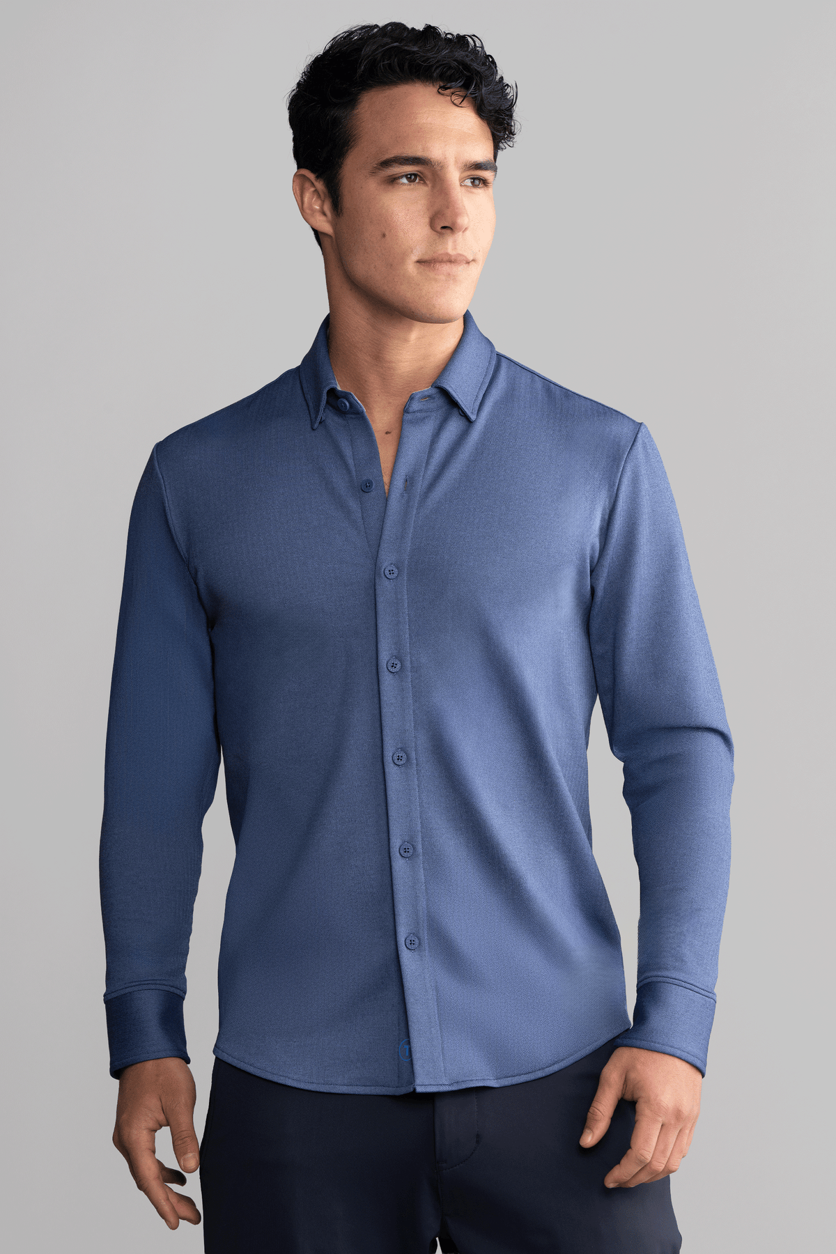 Navy long sleeve button-down polo shirt in herringbone pattern by Twillory, front view showing collar and button details.