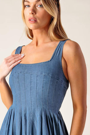 Flying Tomato Passiflora Indigo Denim Midi Dress displayed on a hanger, showcasing its casual denim fabric and midi length.