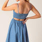 Light indigo Flying Tomato Back in Love Denim Mini Dress, showcasing a stylish casual dress with a fitted silhouette and button details.