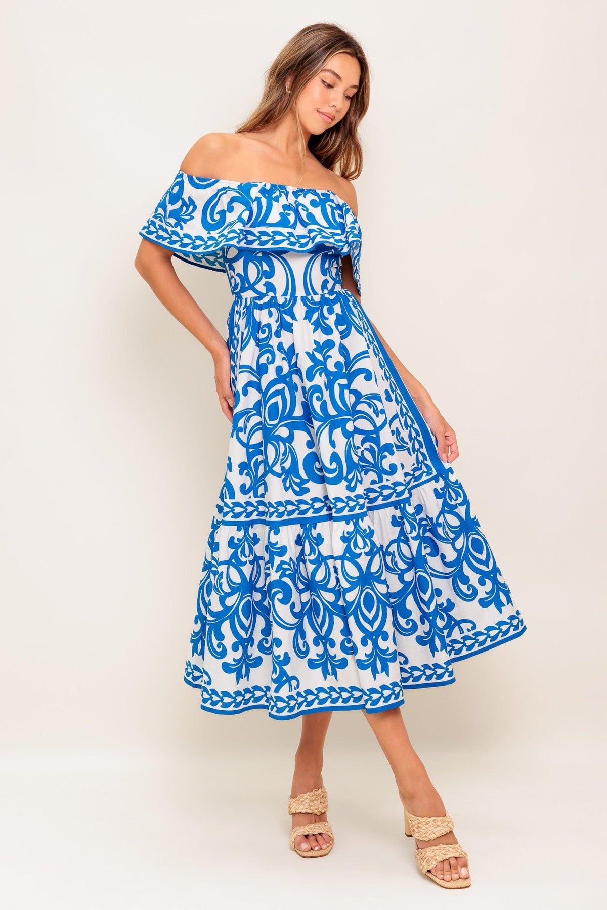 Flying Tomato Bloom Serenade Blue Woven Midi Dress with floral pattern and flowing fabric, displayed on a hanger.