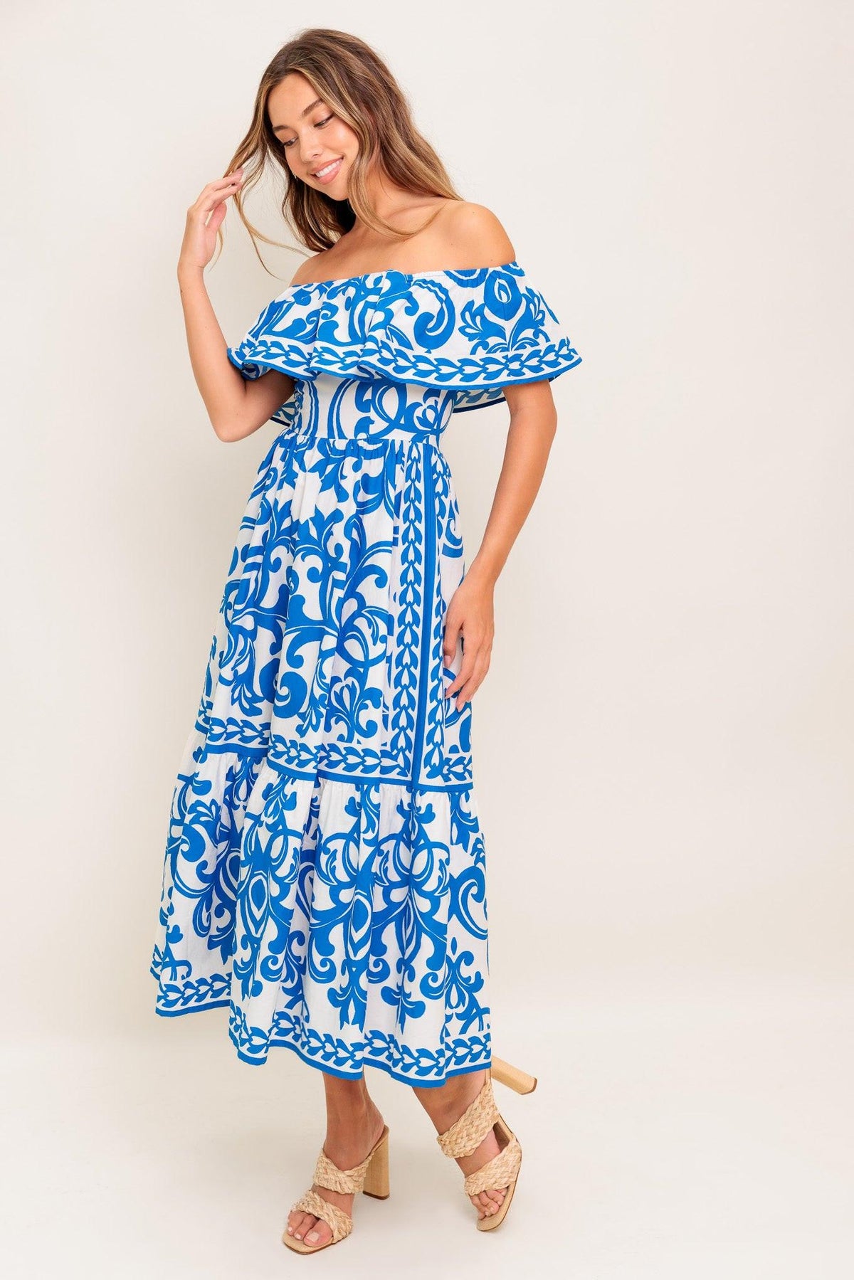Flying Tomato Bloom Serenade blue woven midi dress shown on a model, featuring a flowy silhouette and elegant blue and white pattern.