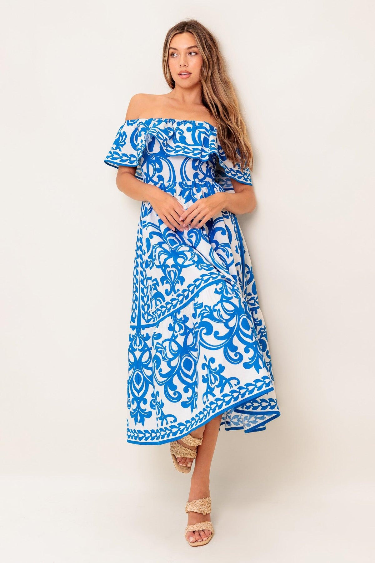 Flying Tomato Bloom Serenade blue woven midi dress displayed on a hanger with floral pattern and flowing fabric.