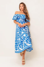 Flying Tomato Bloom Serenade blue woven midi dress displayed on a hanger with floral pattern and flowing fabric.
