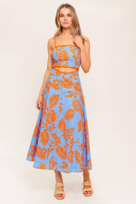 Flying Tomato apricot sunset woven midi dress with blue and orange patterns, flowing fabric and sleeveless design.