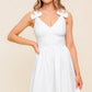 Flying Tomato Lovable Spirit white denim woven mini dress displayed on a hanger with detailed close-up of fabric texture.