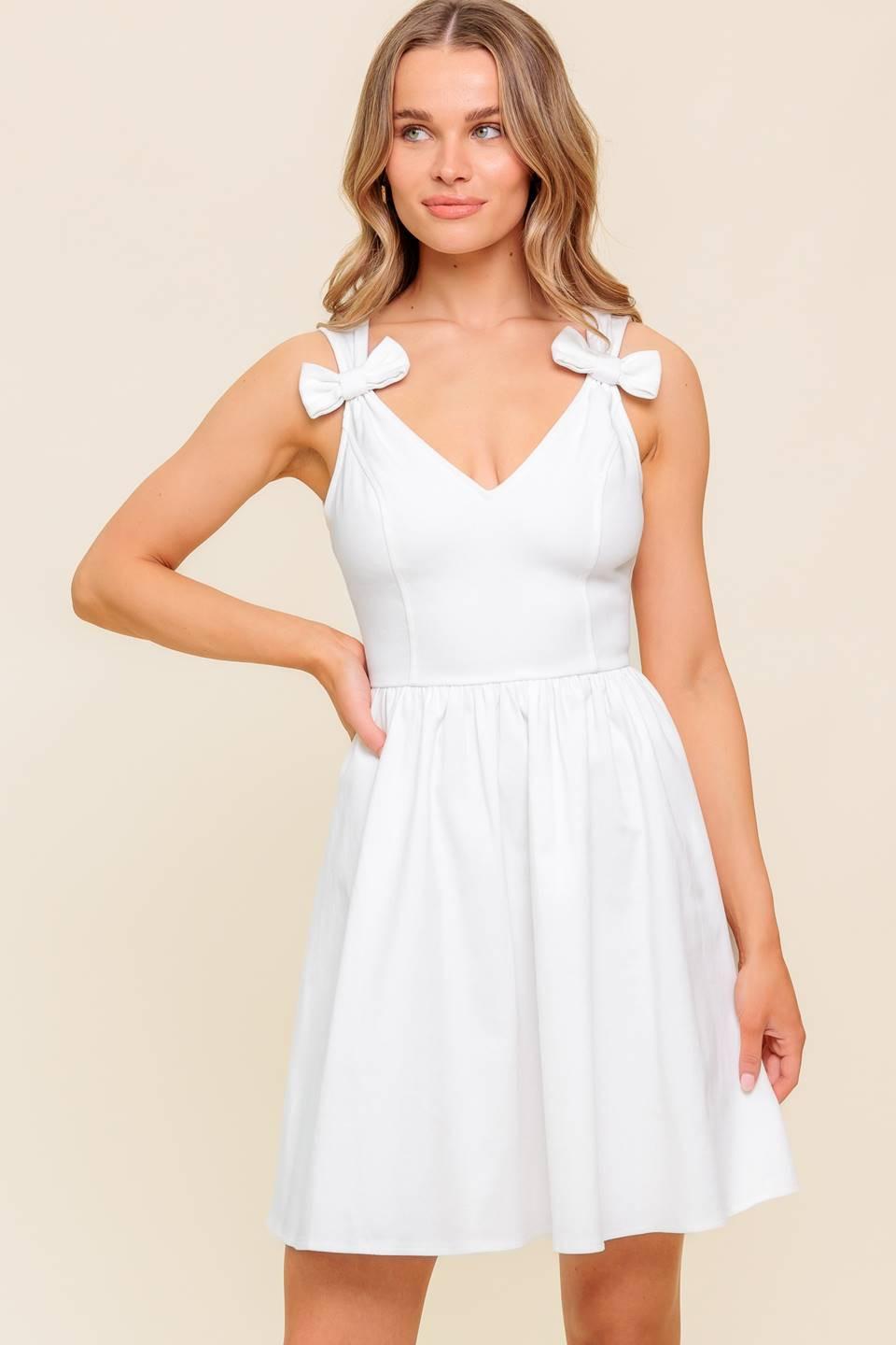 Flying Tomato Lovable Spirit white denim woven mini dress displayed on a hanger with detailed close-up of fabric texture.