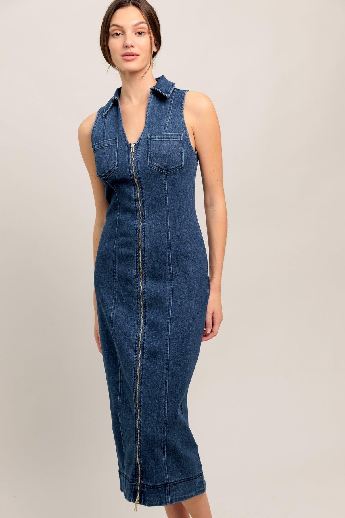 Medium indigo Flying Tomato Everyday Edge Denim Midi Dress shown on a hanger with a fitted silhouette and casual style.