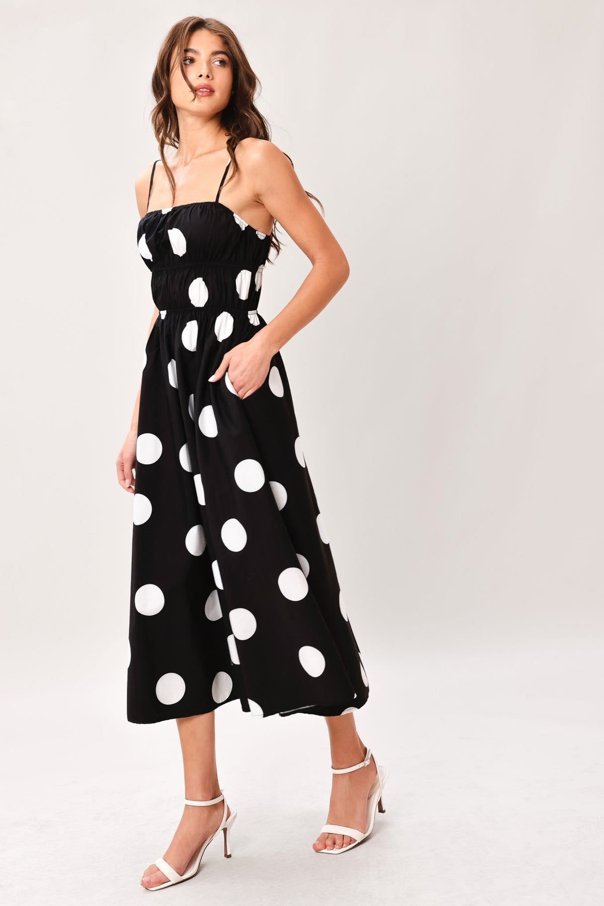 Black DOT THEORY woven midi dress by Flying Tomato featuring a stylish, flowing design with a fitted waist and midi length.