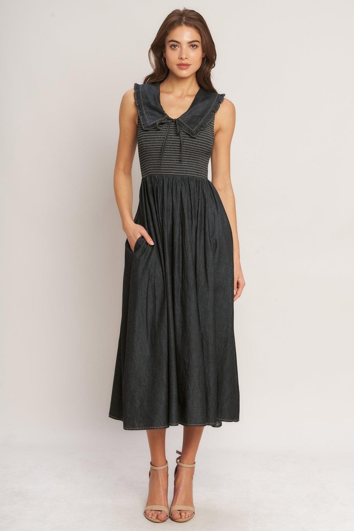 Flying Tomato Dark Elegance woven midi dress in dark indigo with a fitted bodice and flowing skirt, displayed on a hanger.