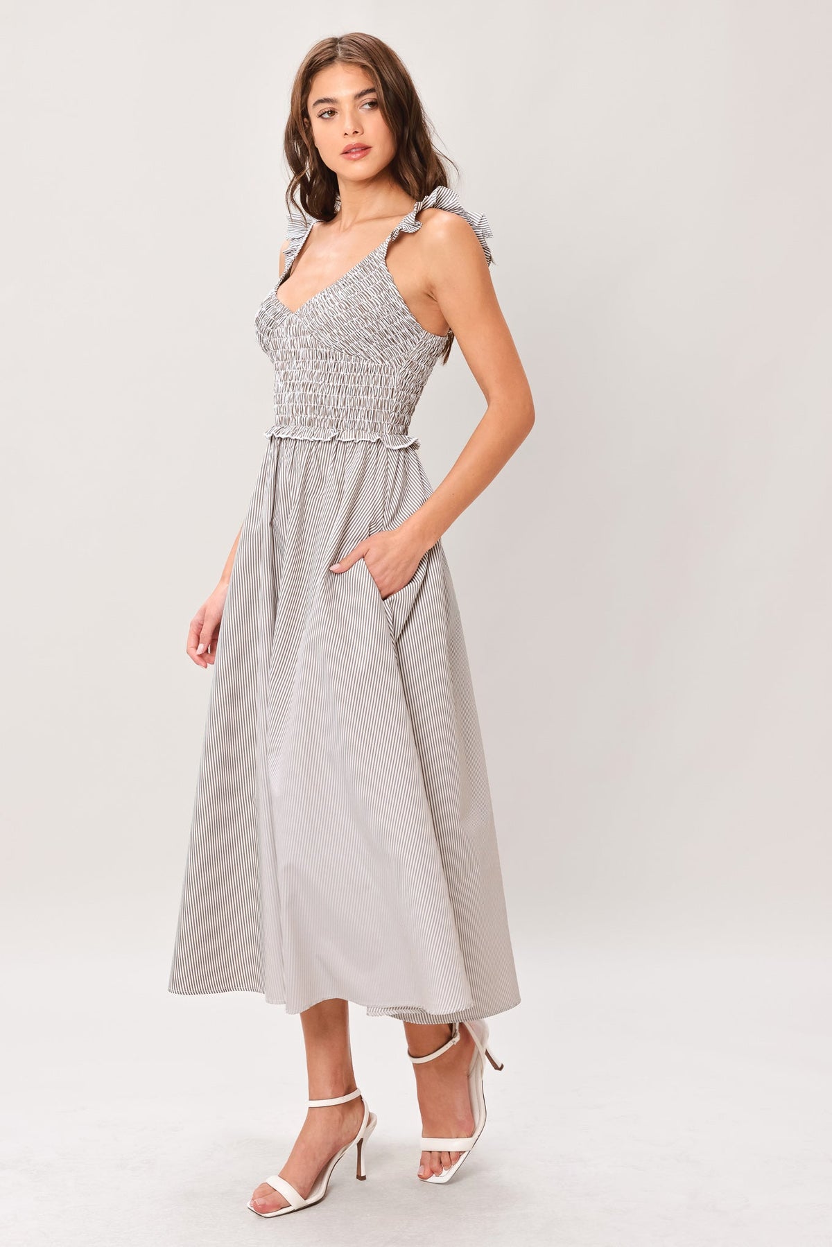 Taupe grey Sweet Stripe woven midi dress by Flying Tomato, featuring a striped pattern and flowing fabric, displayed on a hanger.