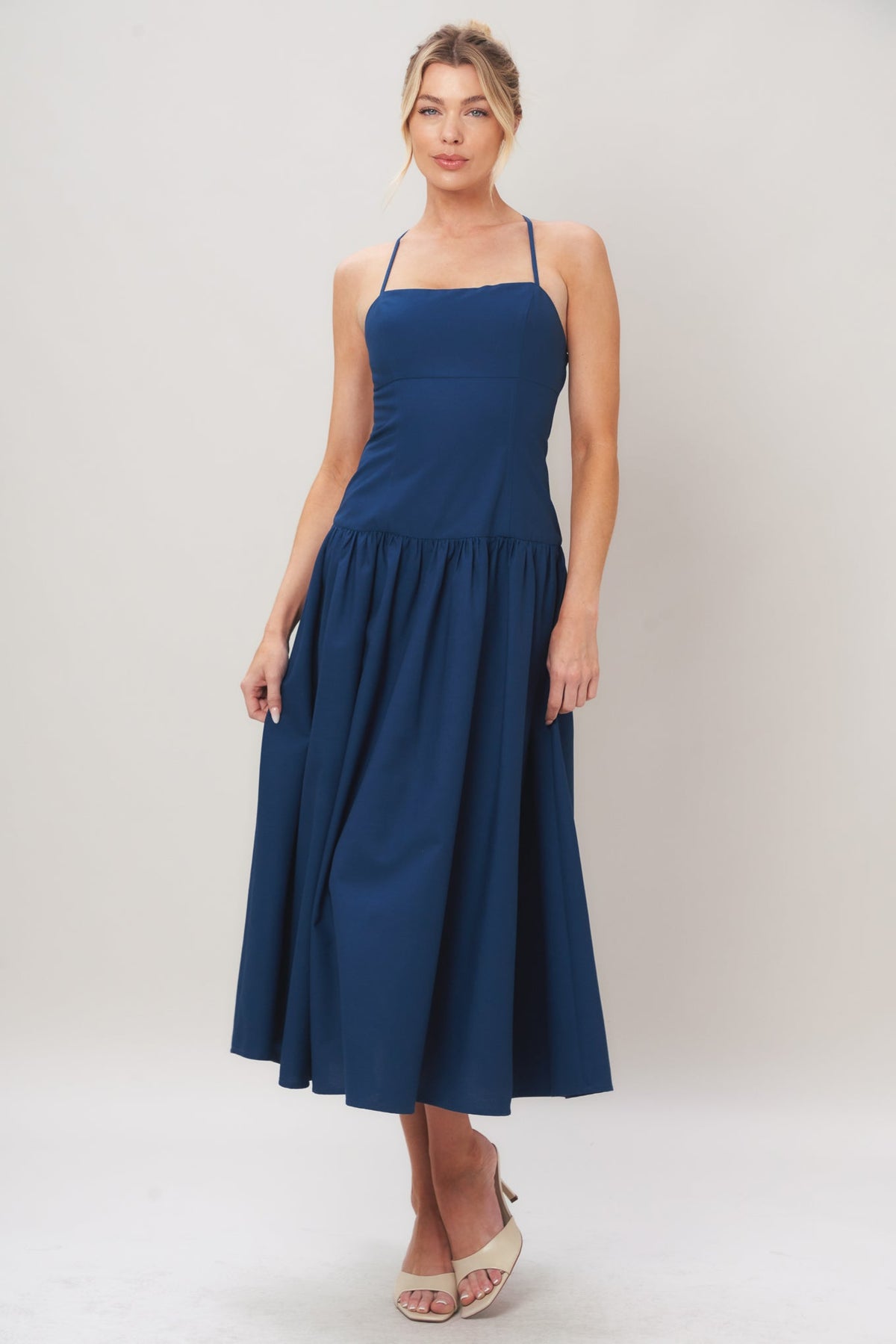 Navy woven midi dress by Flying Tomato featuring a refined flow design and sleeveless style, displayed on a dress form.
