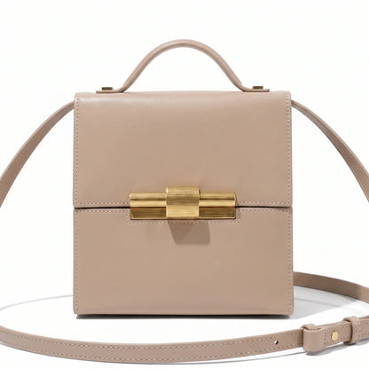 Black leather Nina Cigar Box Bag by thebagicon with a structured rectangular shape and a top handle, detailed with metal hardware.