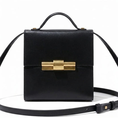 Black leather THE NINA CIGAR BOX BAG by thebagicon with a sleek, structured design and top handle for stylish carry.