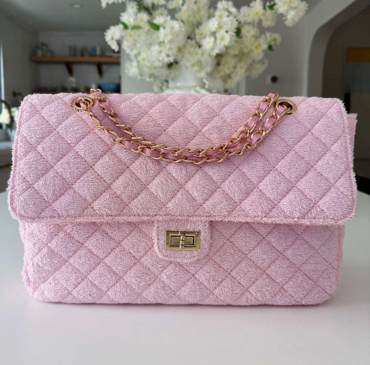 BEACH HAUS Medium Shoreline Flap in blush pink, showing the structured flap design and soft pink finish