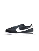 Nike women's Cortez black and white sneakers, side view by Denim Exchange