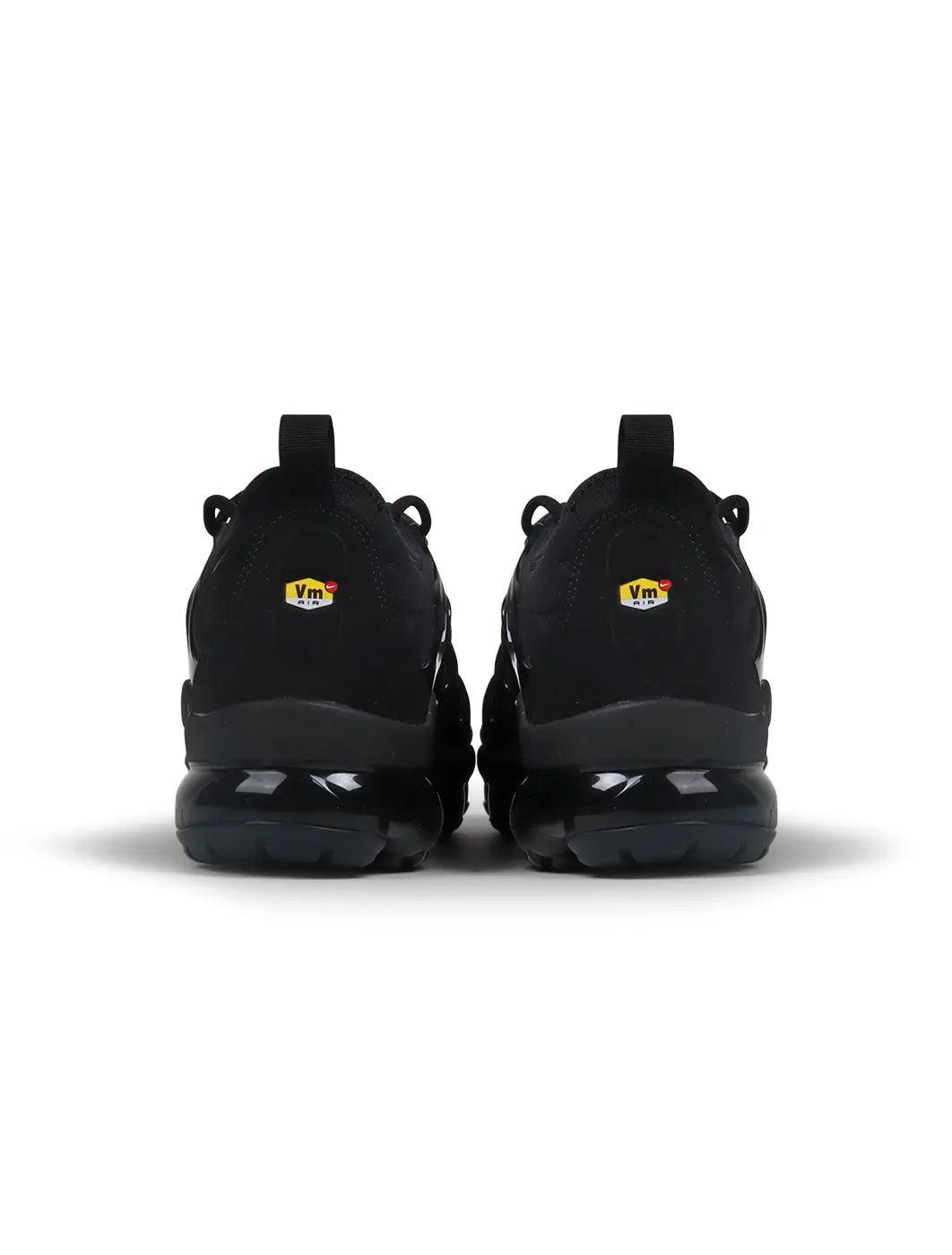 Black Nike Men's Air VaporMax Plus sneakers, side view with visible VaporMax cushioning sole