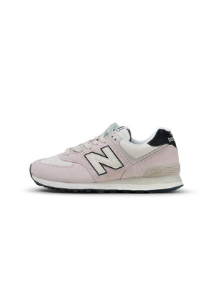 New Balance Women's 574 washed pink sneakers, casual footwear with a soft pink and classic design, suitable for everyday wear.