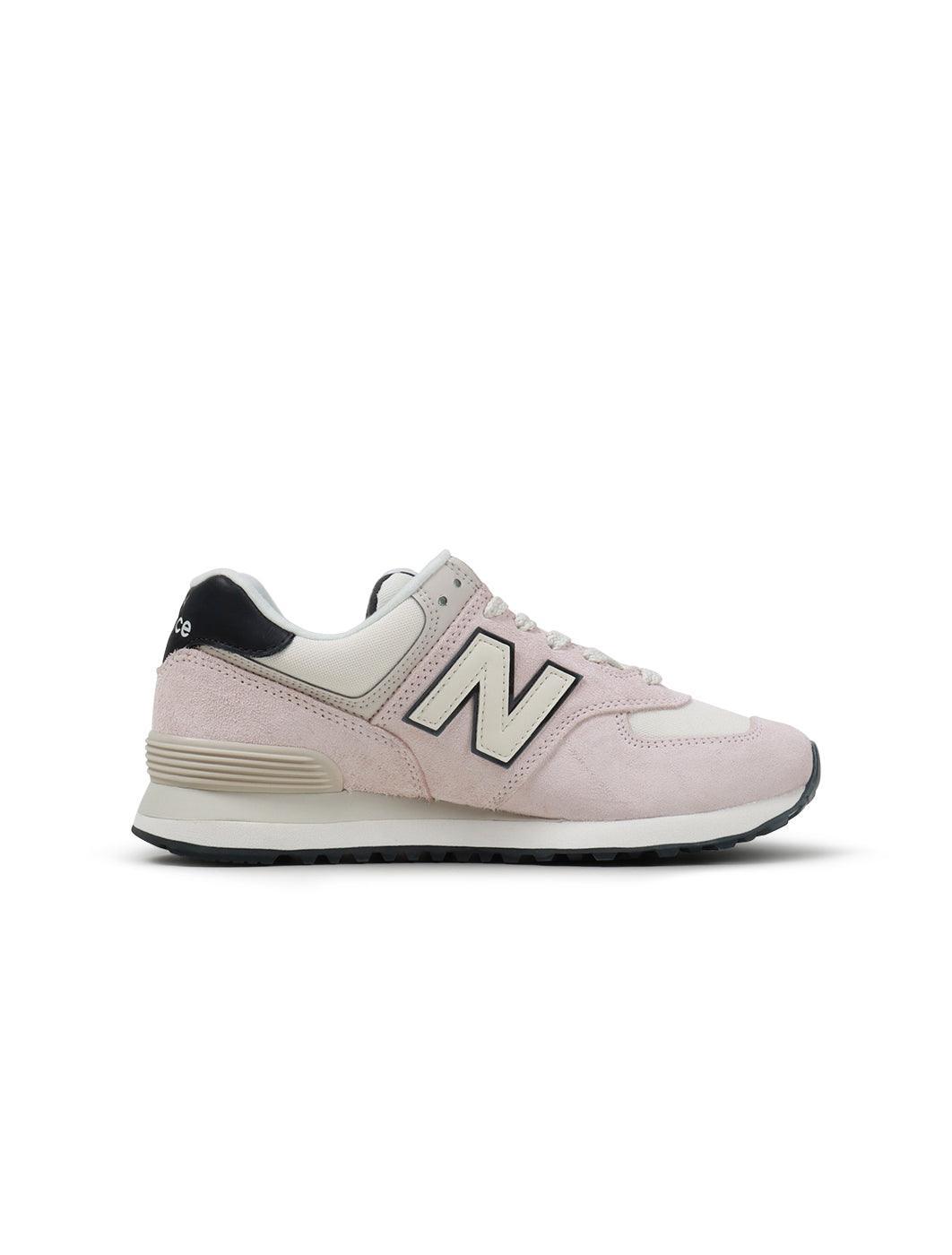 New Balance Women's 574 washed pink sneakers, casual footwear with pink suede and mesh details, stylish and comfortable for everyday wear.