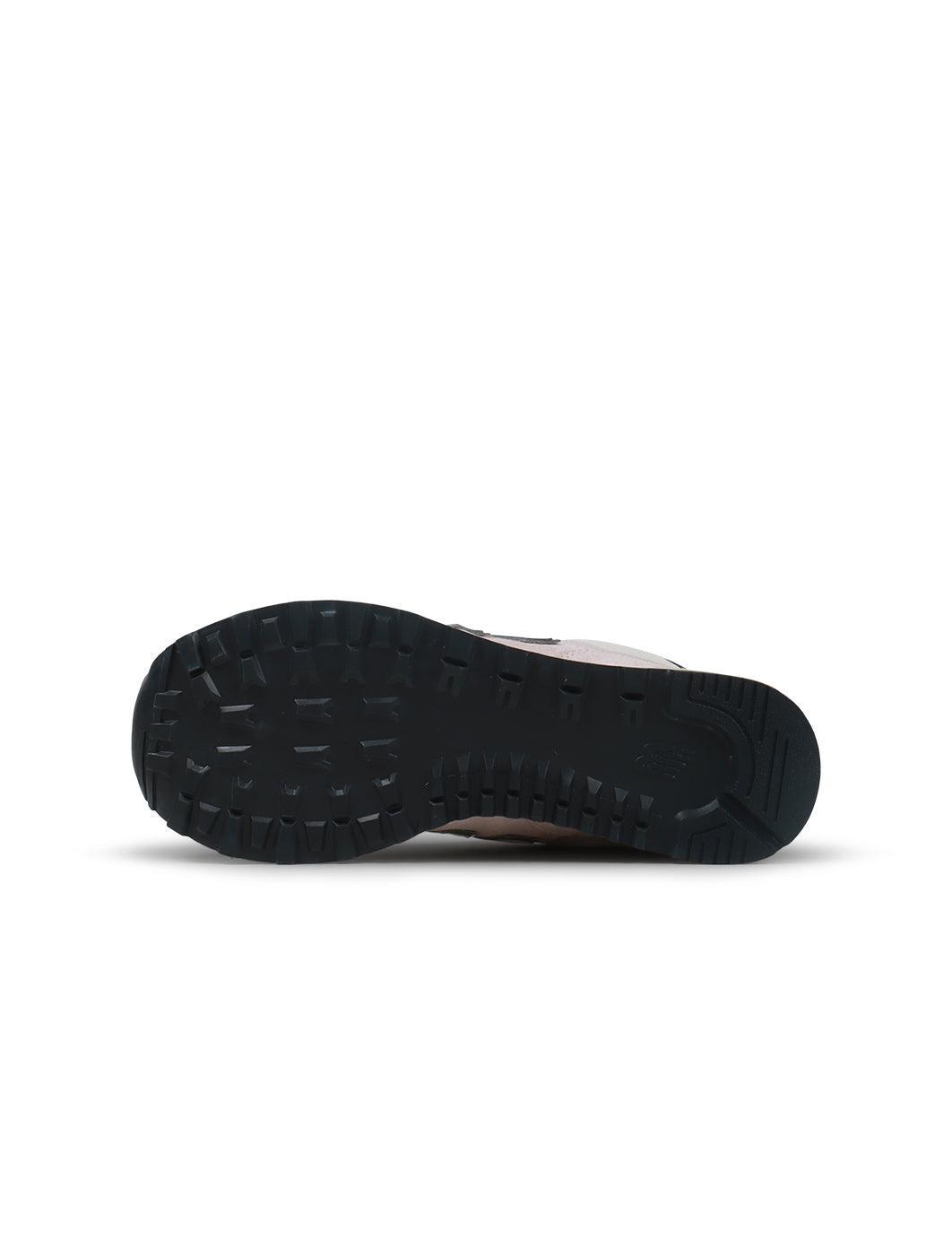 New Balance Women's 574 washed pink sneakers, casual footwear with a soft pink textile upper and classic design.