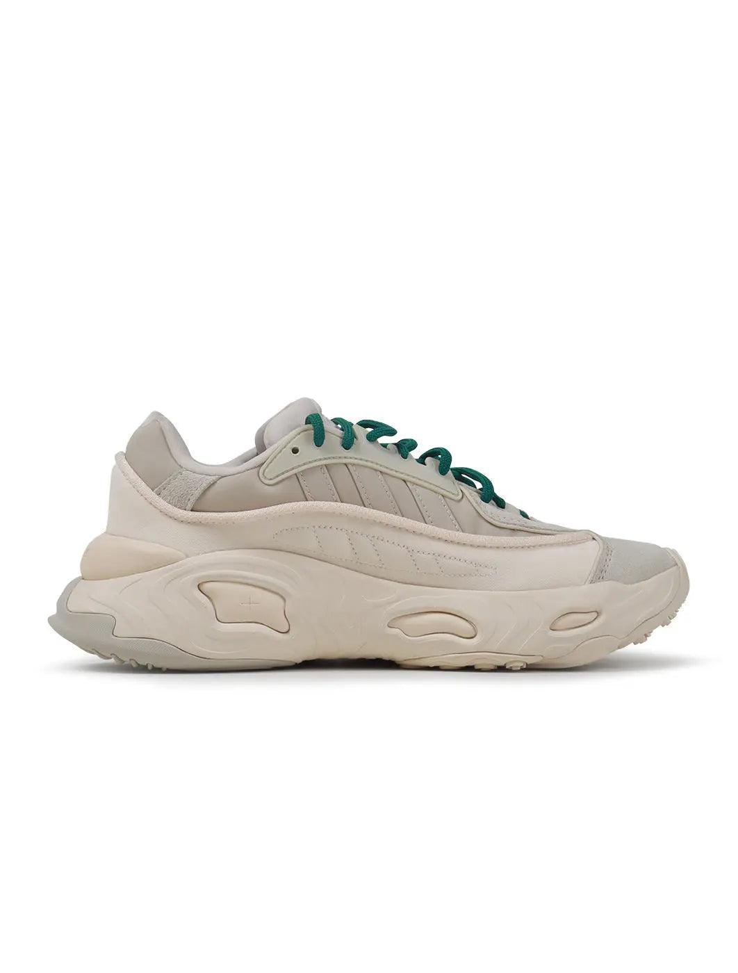 Adidas men's Ozweego sneakers in chalk white, side view from Denim Exchange