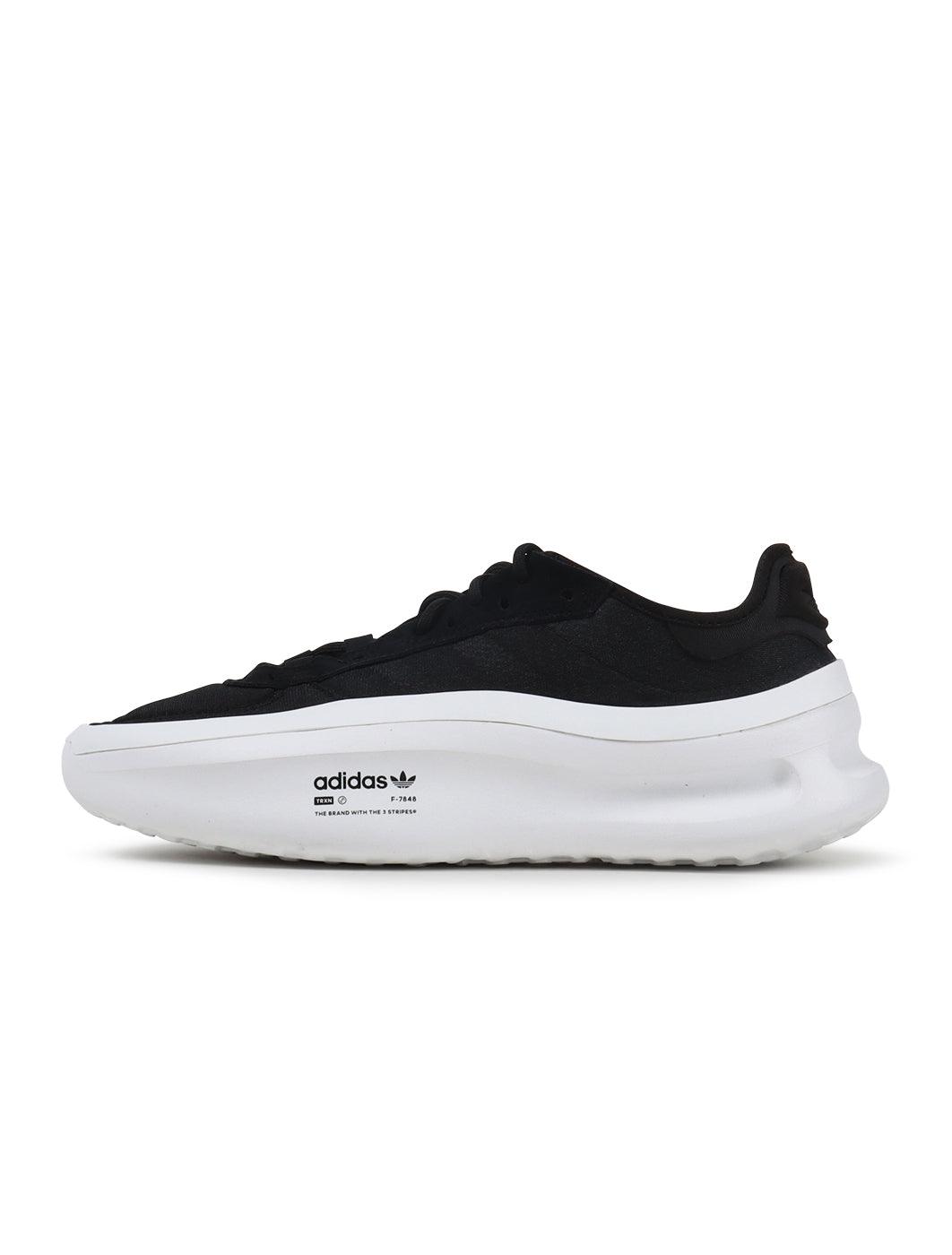 Black and white Adidas men's Adifom Trxn sneakers shown from the side, showcasing sporty footwear design and brand logo.