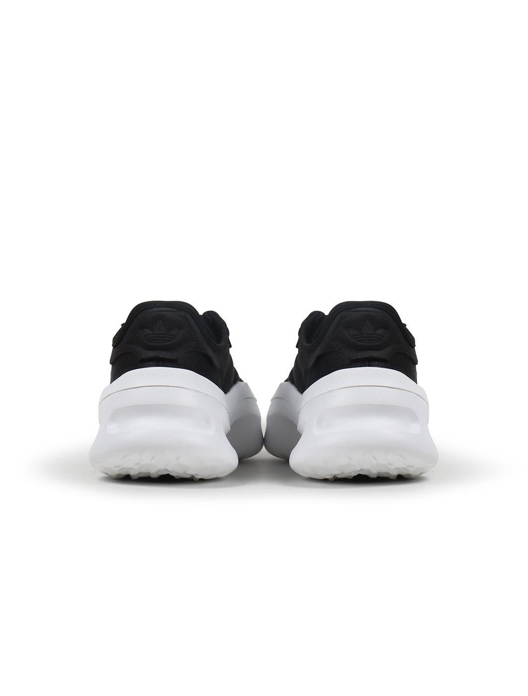 Adidas men's Adifom Trxn black and white athletic sneakers showing side view with laces and cushioned sole.