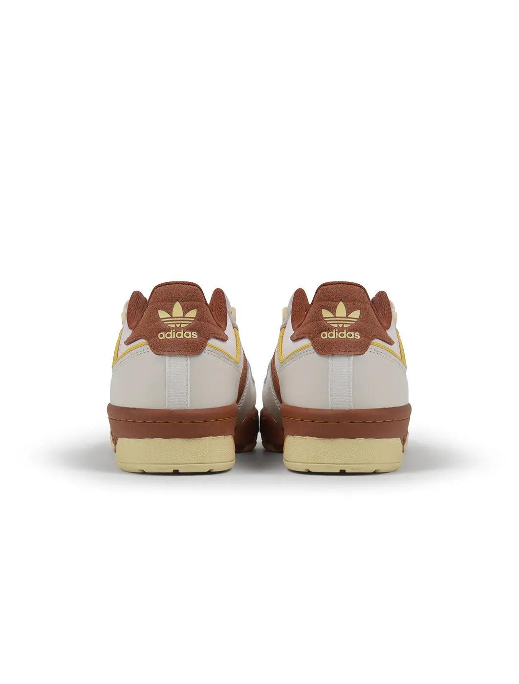 Brown Adidas Mens Rivalry Low 86 sneakers featuring classic low-top design and athletic style, ideal for casual wear.