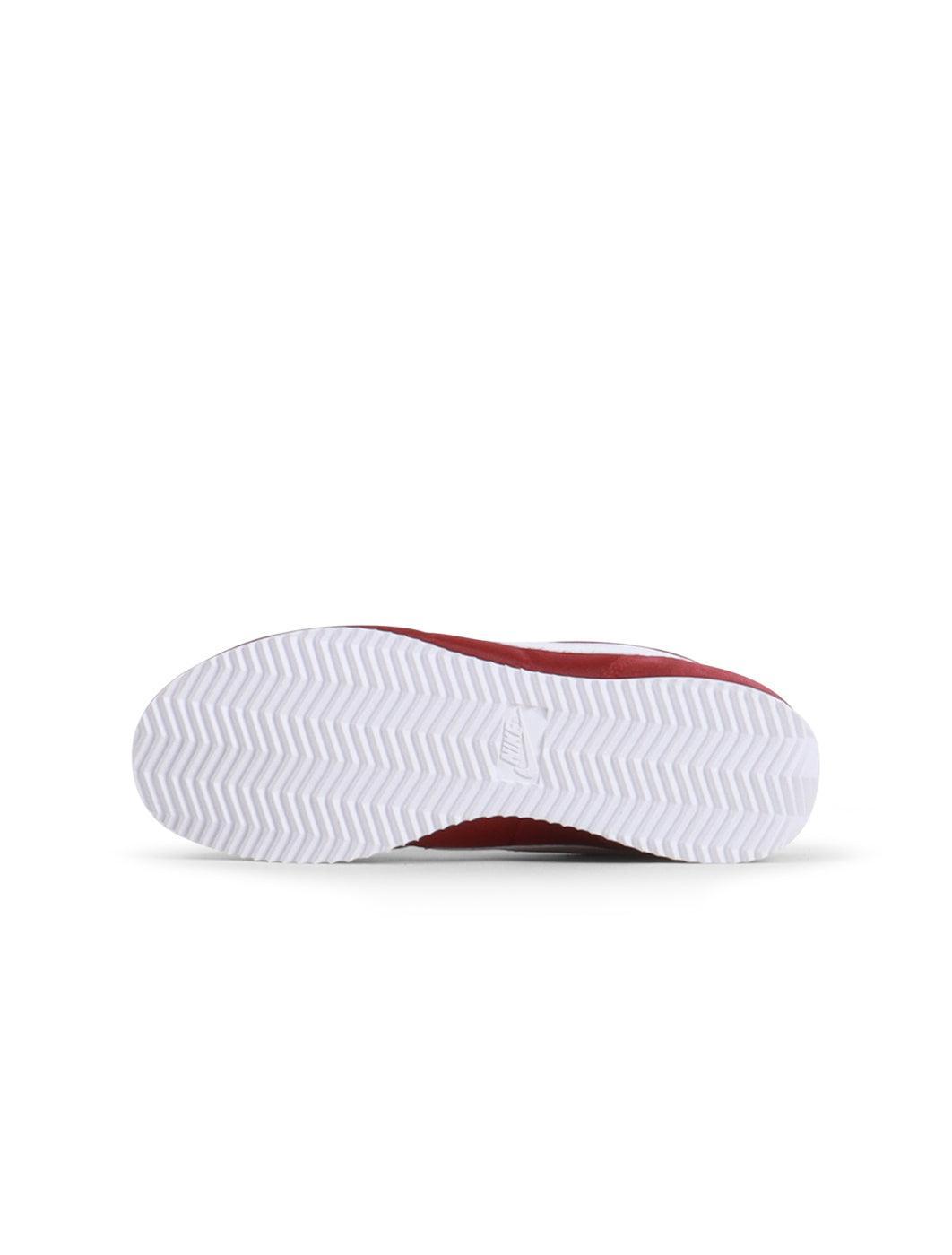 Nike Women's Cortez sneakers in Team Red, showcasing classic design and white sole, perfect for casual wear.