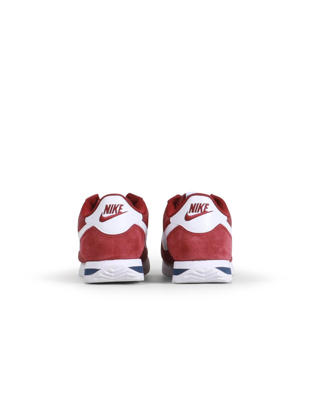 Nike Womens Cortez sneakers in Team Red, stylish women's footwear with classic design and white accents, on a plain background.