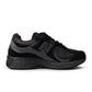 Black New Balance 2002R men's shoes, casual footwear with sleek design and comfortable fit, shown in close-up image.