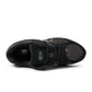 Black New Balance 2002R men's footwear showing side view with textured sole and sleek design.