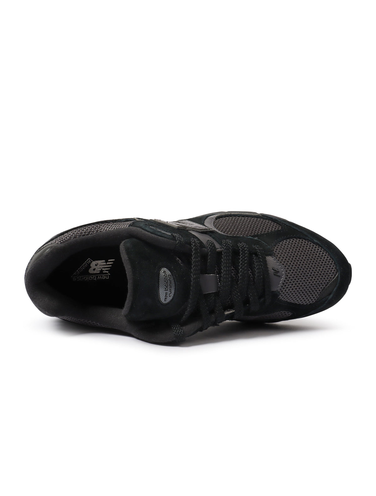 Black New Balance 2002R men's footwear showing side view with textured sole and sleek design.