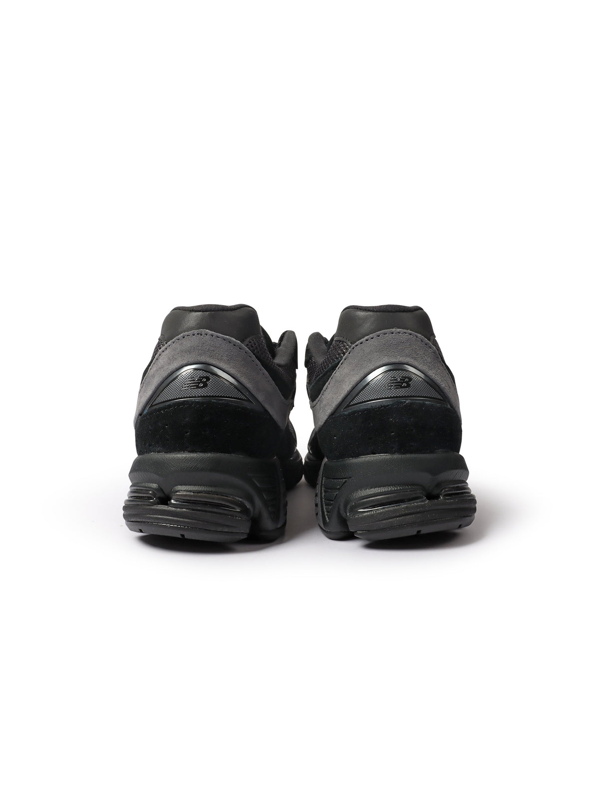Black New Balance 2002R men's shoes, stylish athletic footwear with a sleek design, perfect for casual or active wear.