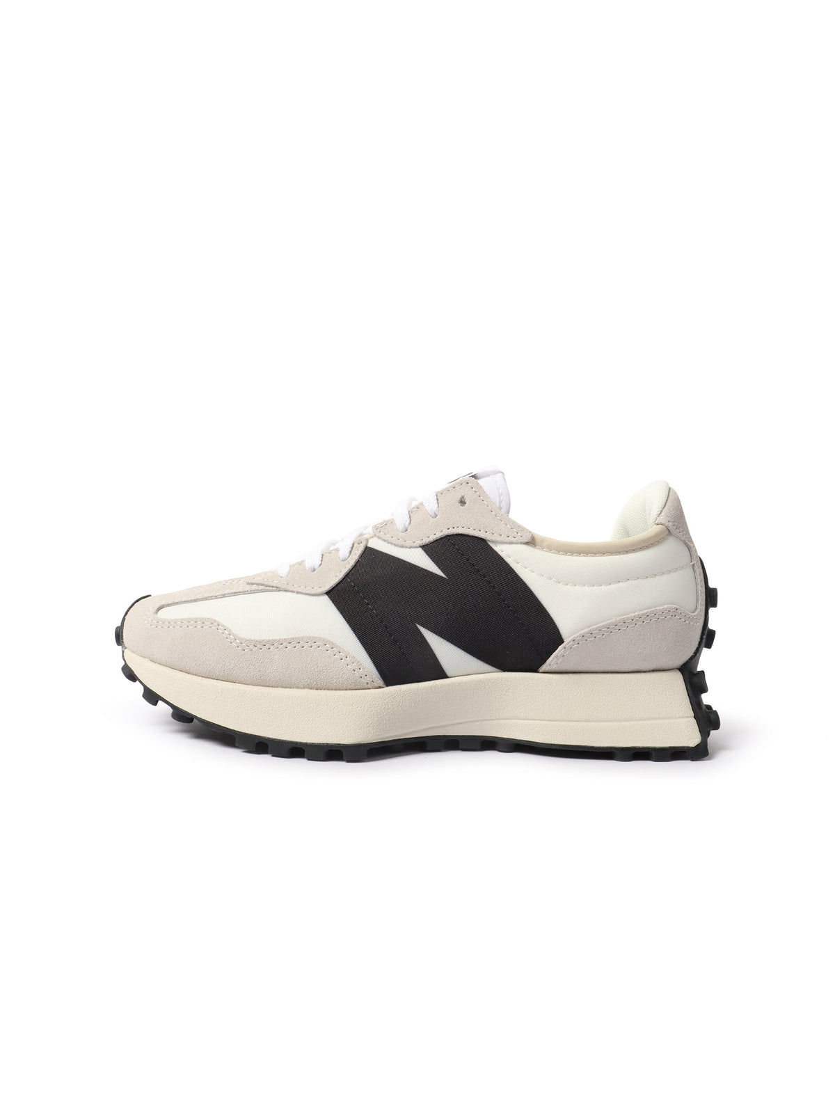 White and black New Balance 327 women's footwear with stylish design and comfortable fit, shown in a close-up image.