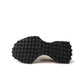 White and black New Balance Women's 327 shoes, stylish footwear with a sleek design, shown in a close-up image.