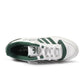 White and green Adidas Forum 84 Low men's sneakers showing side view with classic design and textured sole.