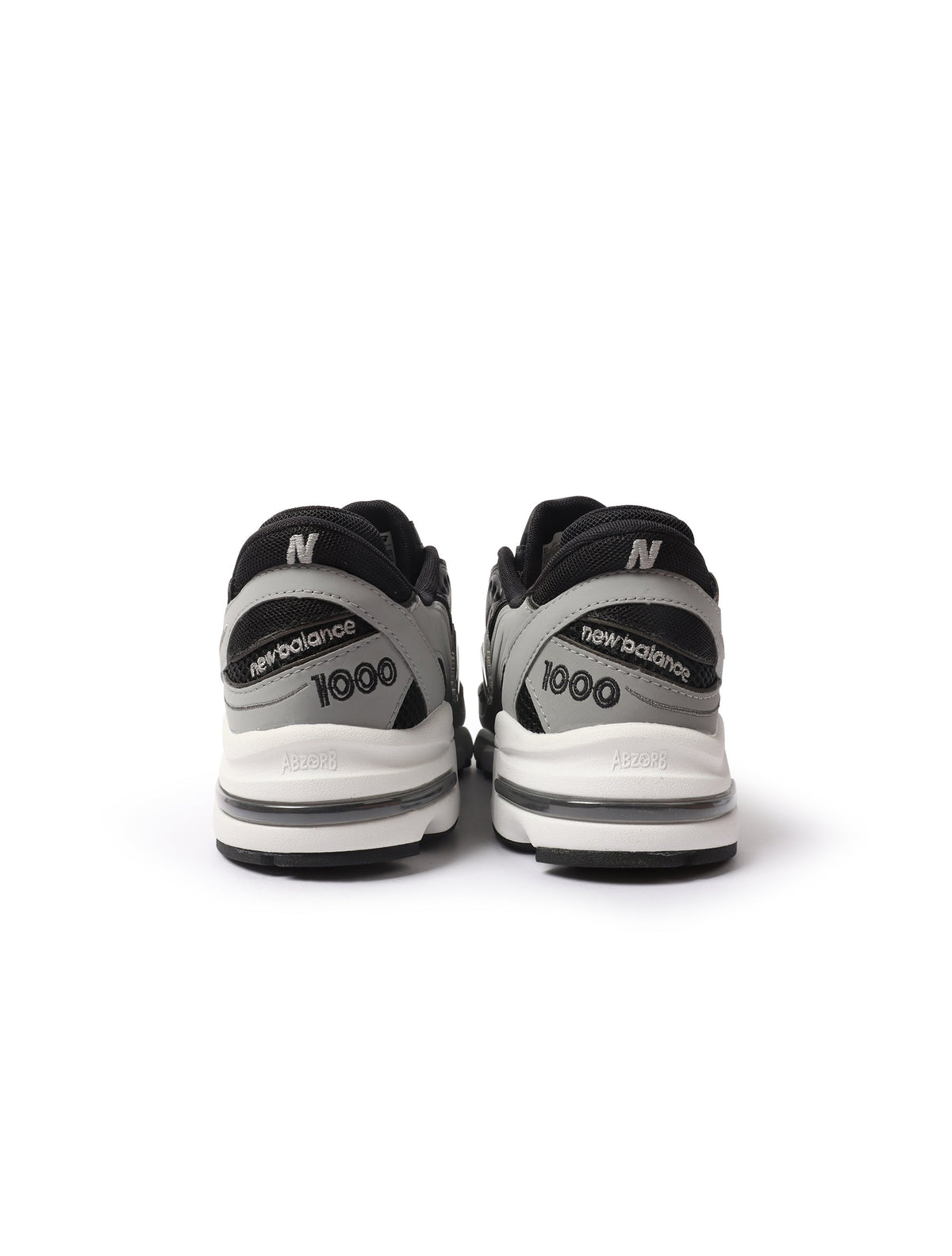 Black and grey New Balance 1000N men's footwear shoes with sporty design and supportive sole, displayed on a white background.