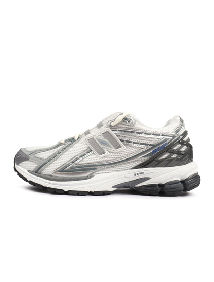 White and grey New Balance men's 1906 sneakers featuring breathable mesh and supportive soles, ideal for casual wear.