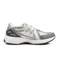 White and grey New Balance men's 1906 sneakers, stylish footwear with mesh accents and cushioned soles.
