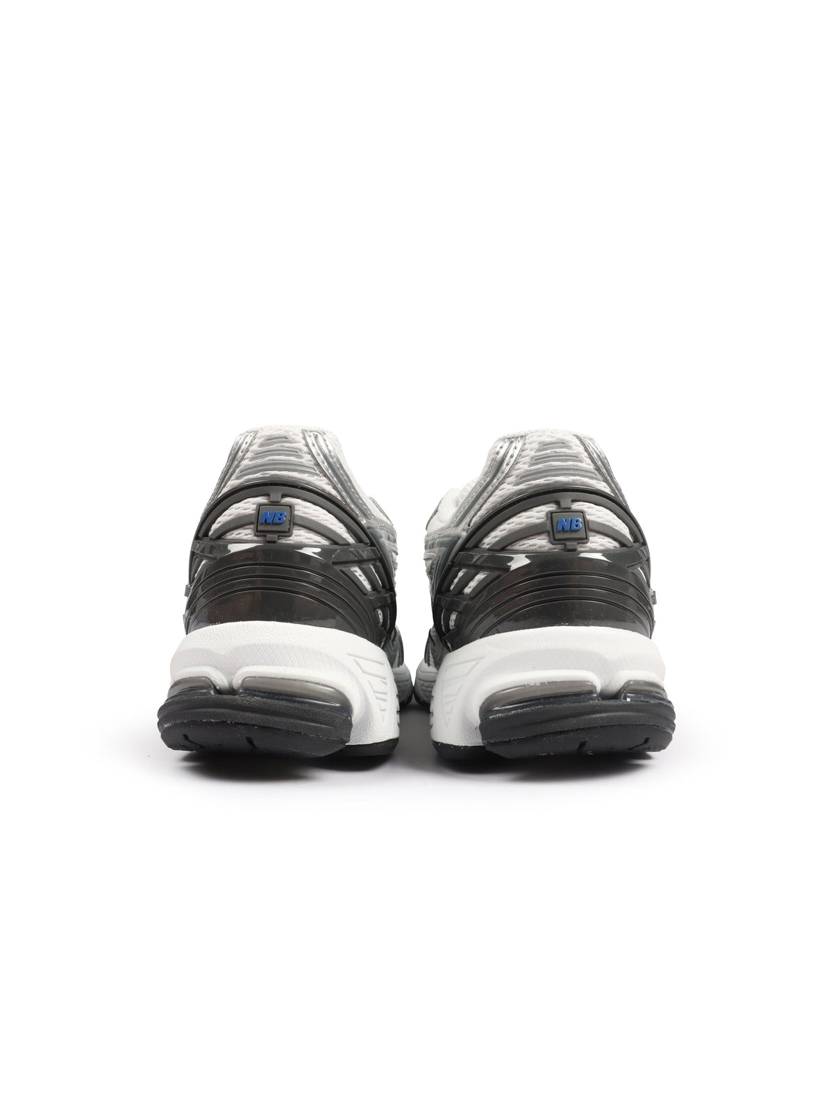 White and grey New Balance men's 1906 sneakers with breathable mesh and supportive soles, shown on a clean background.