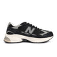 Black New Balance men's footwear with Abzorb cushioning, featuring sleek design and supportive sole, perfect for active wear.